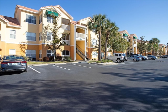 view of building exterior featuring uncovered parking