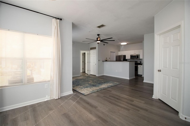 kitchen featuring visible vents, white cabinets, dark wood finished floors, dark countertops, and appliances with stainless steel finishes