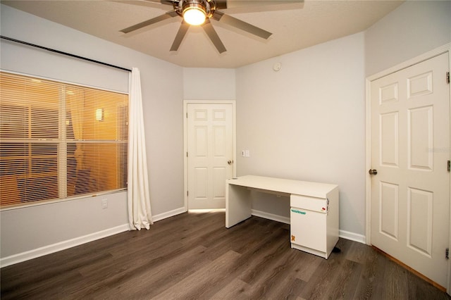 unfurnished bedroom featuring a ceiling fan, dark wood-style flooring, and baseboards