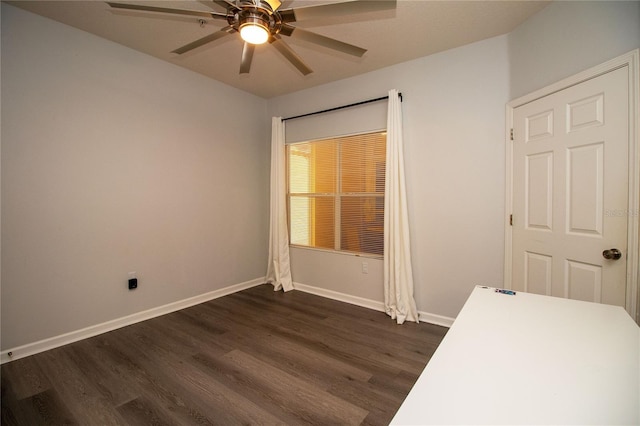 empty room with ceiling fan, baseboards, and dark wood-style flooring