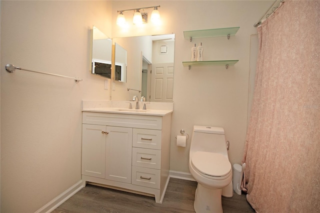 full bathroom featuring toilet, baseboards, wood finished floors, and vanity