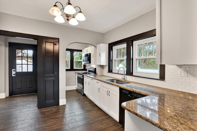 kitchen with pendant lighting, white cabinets, sink, dark hardwood / wood-style floors, and stainless steel appliances