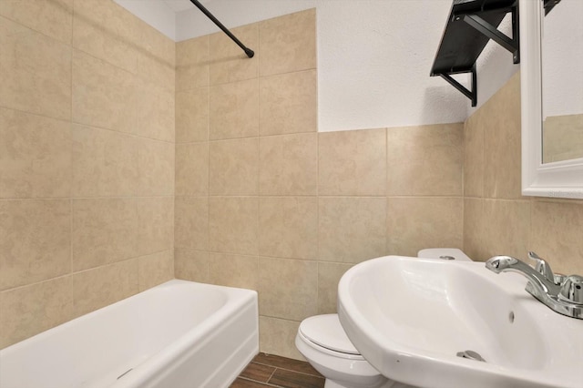 full bathroom with toilet, sink, tile walls, and hardwood / wood-style flooring