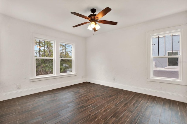 spare room featuring ceiling fan and dark wood-type flooring