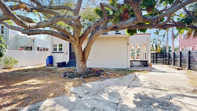 view of side of home with central AC unit