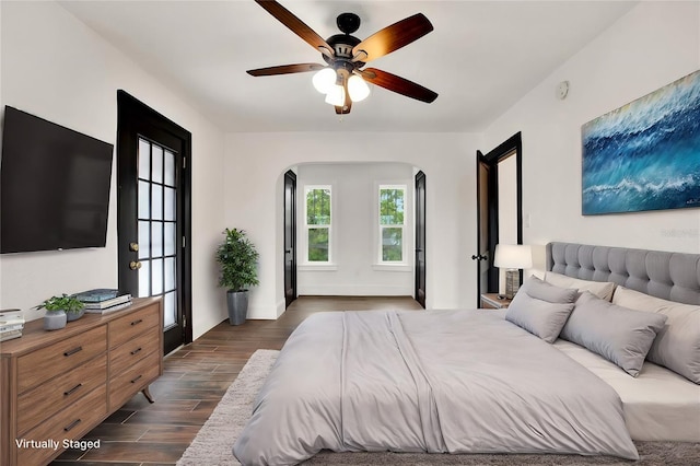 bedroom with ceiling fan and dark wood-type flooring