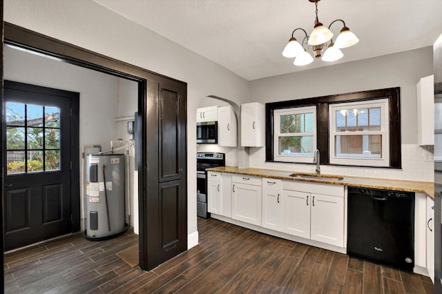 kitchen featuring stainless steel appliances, sink, water heater, pendant lighting, and white cabinets