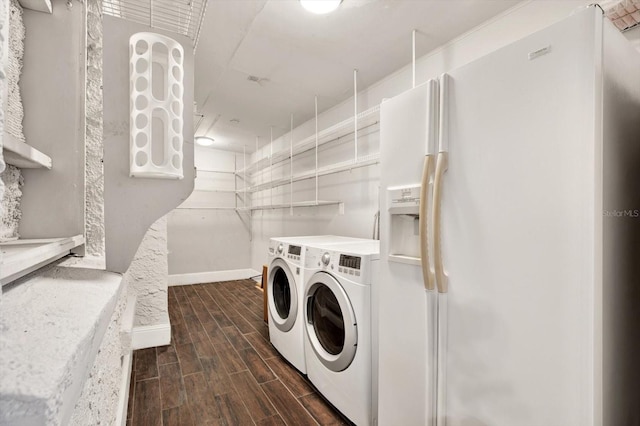 washroom featuring washing machine and clothes dryer and dark wood-type flooring