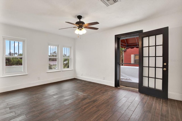 unfurnished room with a textured ceiling, dark hardwood / wood-style flooring, and ceiling fan