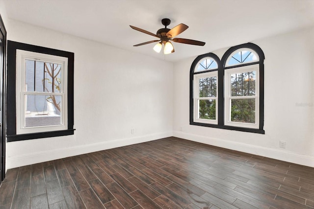 empty room featuring ceiling fan and dark hardwood / wood-style flooring