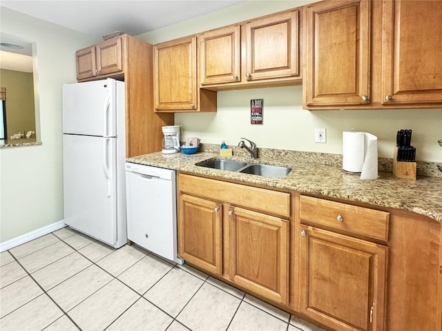 1515 Pinellas Bayway S Unit 40, Saint Petersburg, FL 33715 - kitchen with white appliances, a sink, light tile patterned floors, light stone countertops, and baseboards