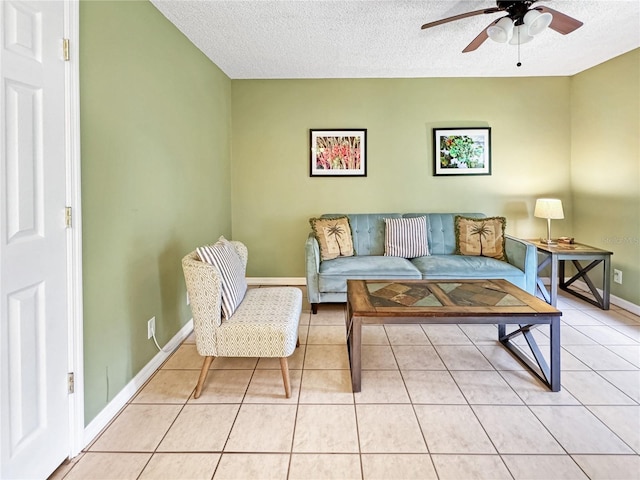 tiled living room with ceiling fan and a textured ceiling