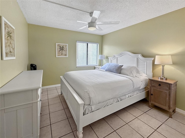 tiled bedroom with ceiling fan and a textured ceiling