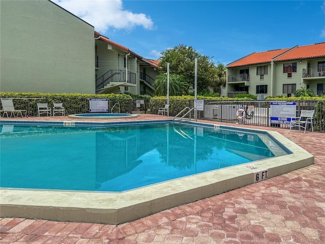 view of pool with a community hot tub