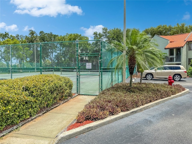 1515 Pinellas Bayway S Unit 40, Saint Petersburg, FL 33715 - view of tennis court with a gate