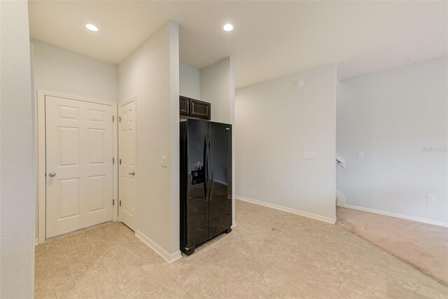 kitchen featuring black refrigerator with ice dispenser, recessed lighting, dark brown cabinetry, and baseboards