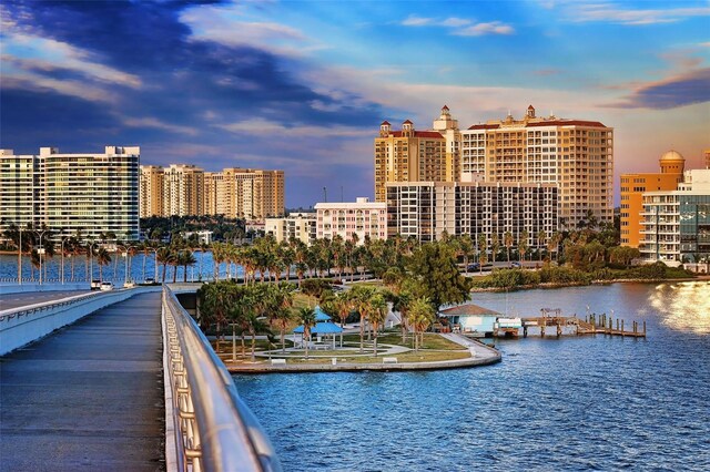 exterior space with a water view and a city view