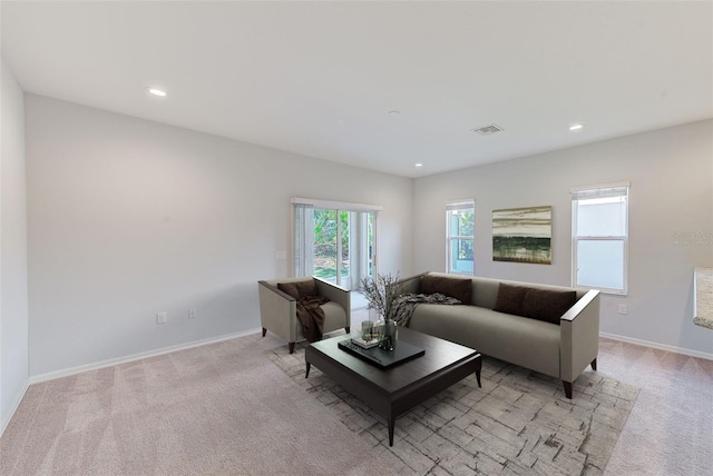 living area featuring recessed lighting, light carpet, visible vents, and baseboards