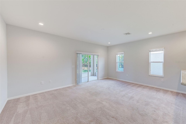 unfurnished room with recessed lighting, carpet, visible vents, and baseboards