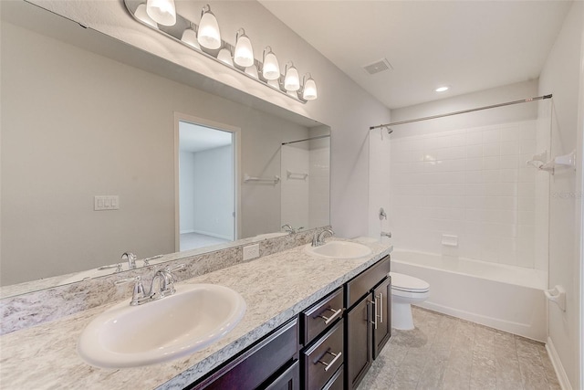 full bath featuring visible vents, a sink, toilet, and double vanity