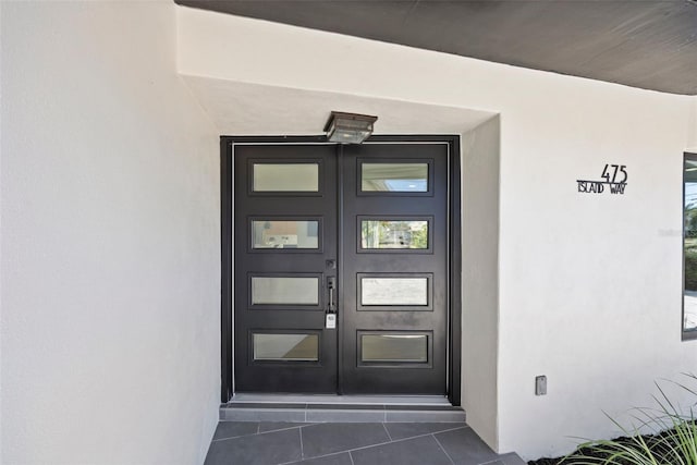 475 Island Way, Clearwater Beach, FL 33767 - view of exterior entry with stucco siding and french doors