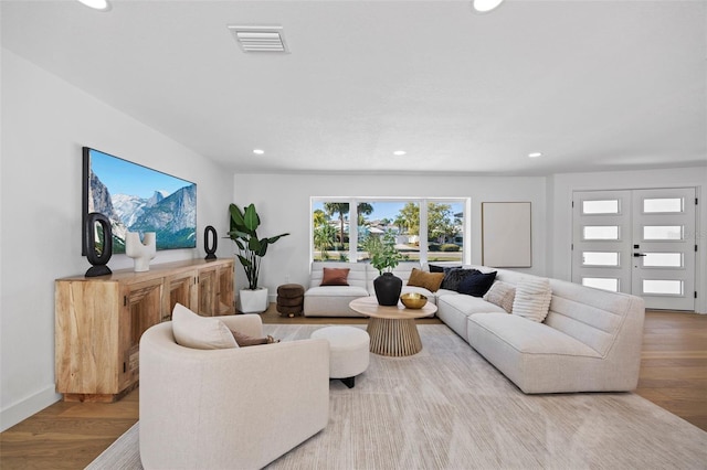 living room featuring french doors and hardwood / wood-style flooring