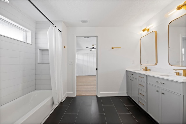 bathroom with vanity, tile patterned floors, ceiling fan, a textured ceiling, and shower / tub combo with curtain