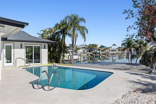 view of pool featuring a water view and a patio