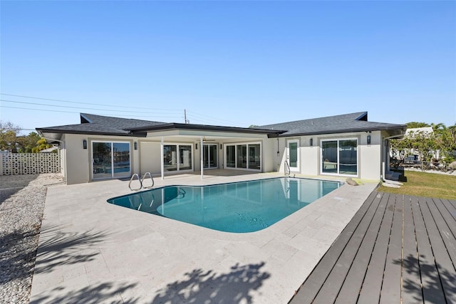 view of swimming pool with a patio and a deck