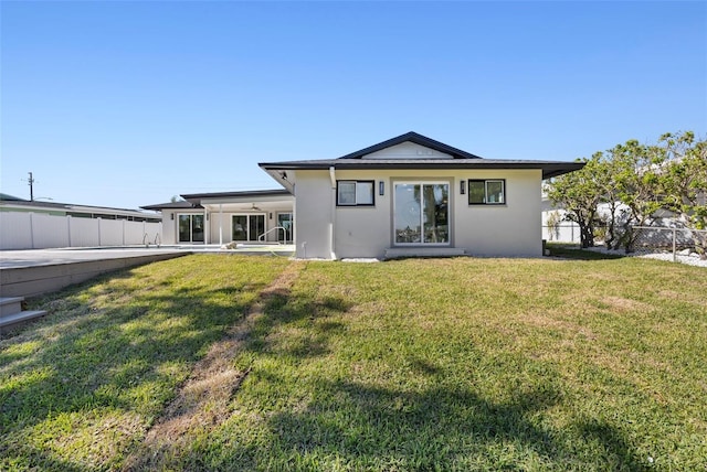 back of house featuring a yard and a patio