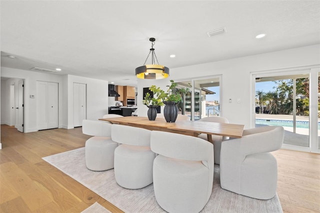 dining space with a wealth of natural light and light hardwood / wood-style flooring