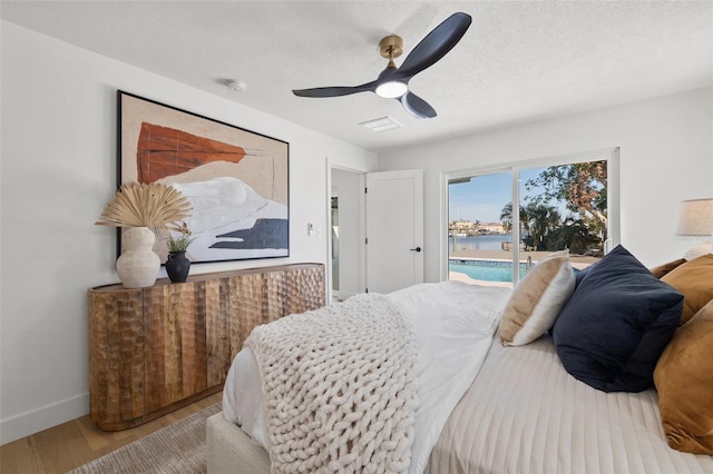 475 Island Way, Clearwater Beach, FL 33767 - bedroom with access to exterior, wood finished floors, and a ceiling fan