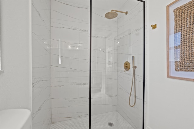 bathroom with tiled shower