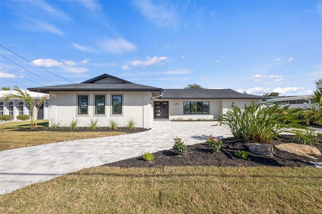 475 Island Way, Clearwater Beach, FL 33767 - view of front of property with stucco siding and a front lawn