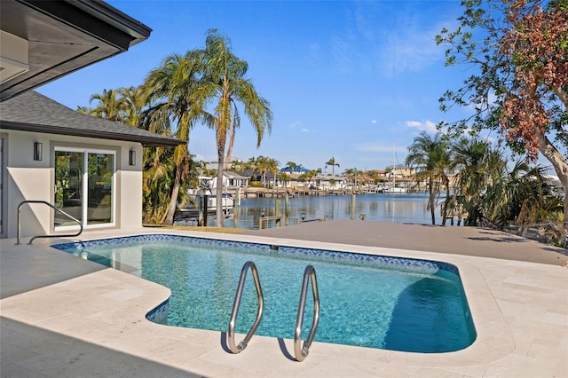 view of swimming pool featuring a patio area and a water view