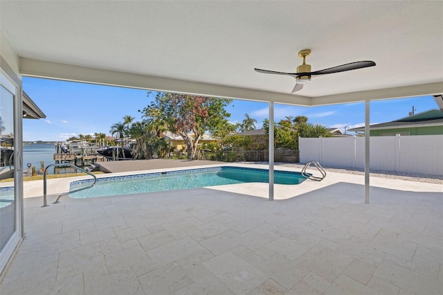 view of swimming pool with a water view and a patio