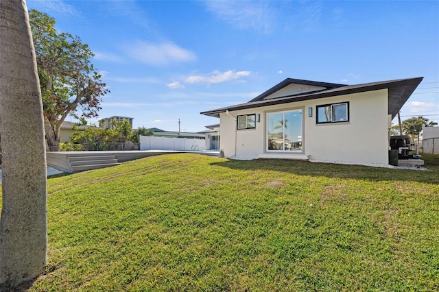 rear view of property featuring a yard