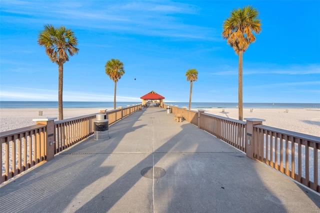 surrounding community featuring a beach view and a water view