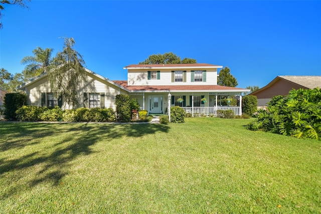 view of front of house with a front yard and a porch