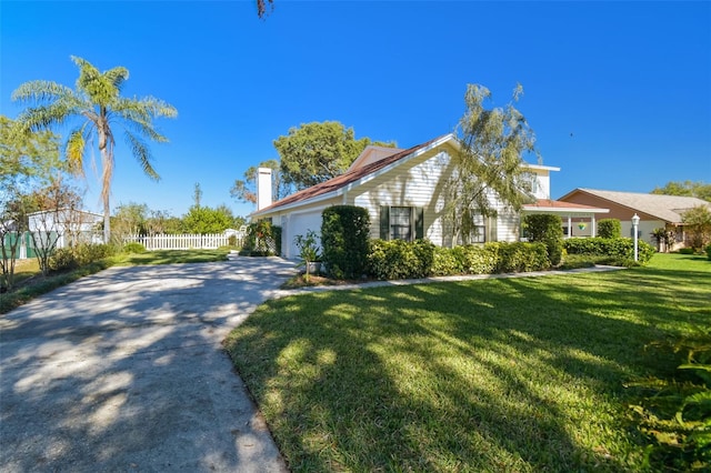 view of side of home featuring a yard and a garage