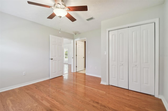 unfurnished bedroom featuring ceiling fan, light hardwood / wood-style floors, a textured ceiling, and a closet