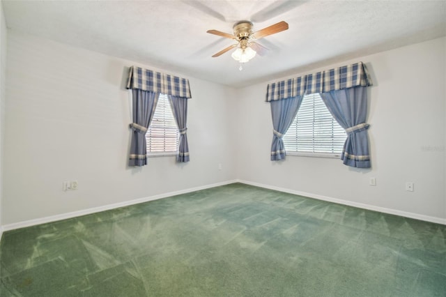 carpeted spare room with ceiling fan and a wealth of natural light