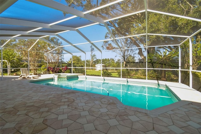 view of swimming pool featuring glass enclosure and a patio