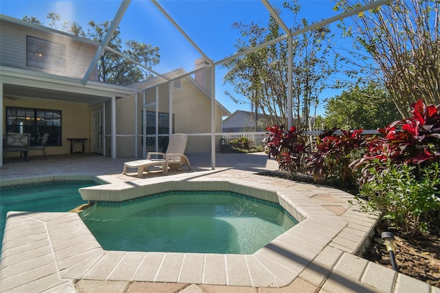 view of swimming pool with a patio and glass enclosure