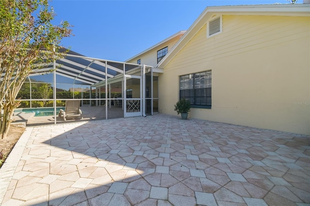 view of patio featuring a lanai