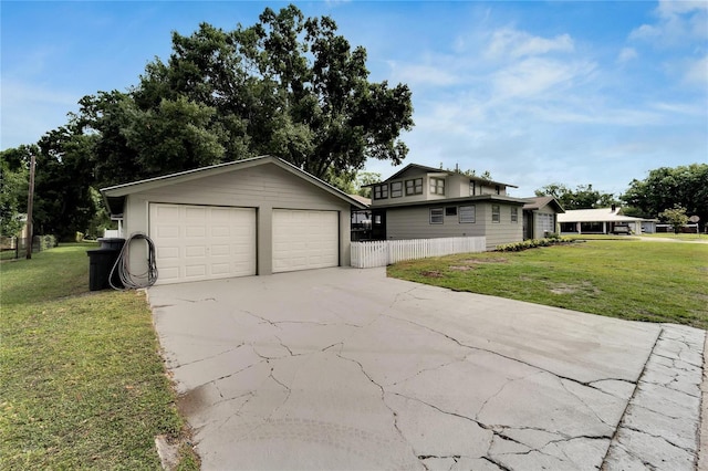 exterior space featuring a front yard, a garage, and an outdoor structure