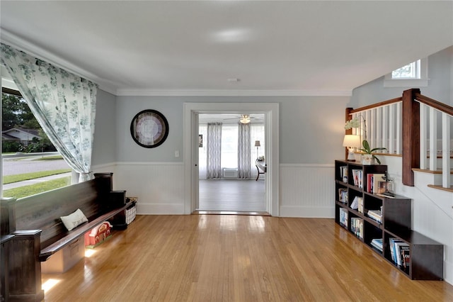 interior space featuring a wealth of natural light, light hardwood / wood-style flooring, and ornamental molding