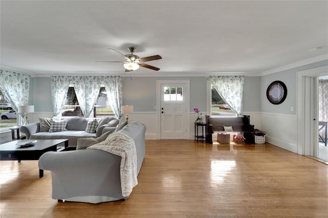 living room with ceiling fan, light hardwood / wood-style floors, and ornamental molding