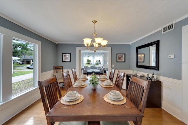 dining space with plenty of natural light and light hardwood / wood-style floors