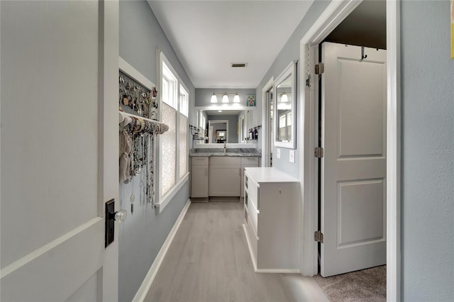 corridor featuring light hardwood / wood-style flooring